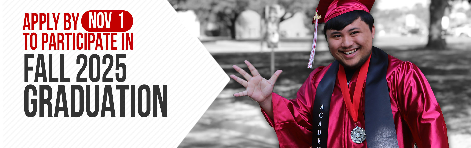 Graduate student wearing full commencement cap and gown waving to the camera